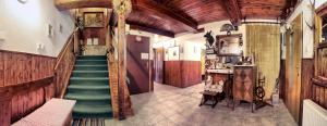 a hallway with a staircase in a building with wooden ceilings at Pension U Stehlíků in Růžová