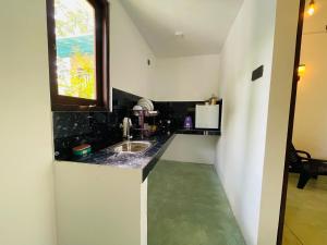 a small kitchen with a sink and a window at Wind Hill Villa - Weligama in Weligama +27 photos