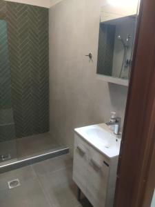 a bathroom with a shower and a sink and a mirror at Stylianos House 6 in Leonidion