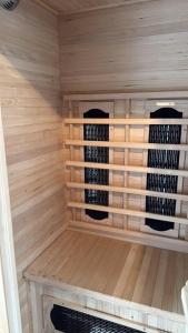 a sauna with two bottles of wine in it at Vakantiehuis Strand ,water,met infraroodsauna in Breskens