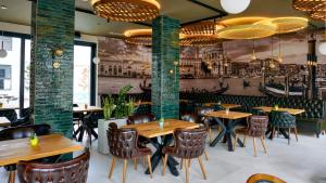 a restaurant with wooden tables and chairs and a mural at POOL RESORT- Vila Lena- Apartman 2 in Vrdnik