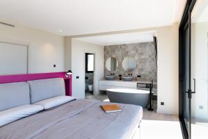 a bedroom with a bed and a bath tub and a sink at VILLAS COSETTTE Villa VICENC in Platja  d'Aro +45 photos
