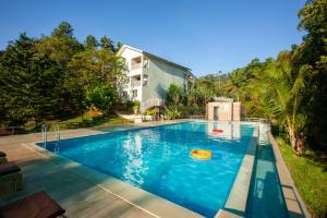 a swimming pool in the backyard of a house at Broad Bean Resort & Spa in Munnar