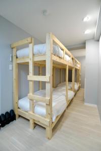 a room with three bunk beds in a room at Chaya Building in Toyohira