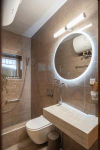 a bathroom with a sink and a toilet and a mirror at Elia Guesthouse Chaidemeni in Tríkala +26 photos