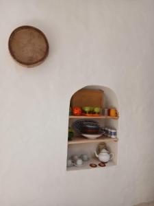an open refrigerator with some food in it at Dar El Hara in Houmt Souk