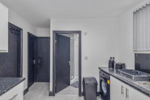 a kitchen with black cabinets and a glass door at Luxury 2BR Retreat Sheldon in Sheldon