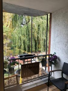 a balcony with a view of a garden with a piano at Cocktailpedia - Apartment mit Loggia in Wesel