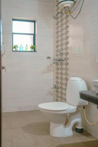 een badkamer met toilet, douche en wastafel bij Sukoon by Second Homes in Candolim