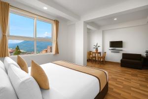 a white bedroom with a large bed and a window at TVD Hotel Polaris Gangtok Near MG Marg in Gangtok