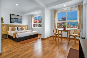 a bedroom with a bed and a table and a dining room at TVD Hotel Polaris Gangtok Near MG Marg in Gangtok +17 photos