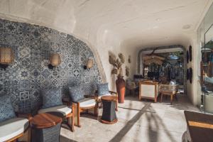 a room with a bunch of chairs and tables at Aleva Villa Seminyak by Ini Vie Hospitality in Seminyak