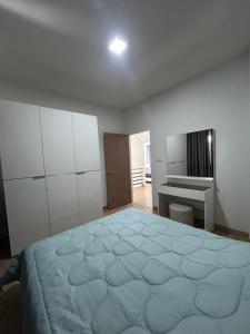 a bedroom with a large bed and a desk at SW-home R2 in Chiang Mai