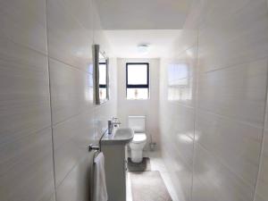 a white bathroom with a sink and a toilet at Greenview Haven in Stompneusbaai +23 photos