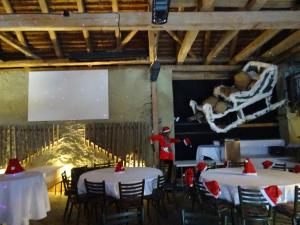 a room with tables and a teddy bear laying on a swing at Eventhotel Ö - Cappuccino in Geiselwind