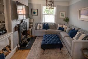 a living room with a couch and a fireplace at Seaside 5-Bed Coastal Getaway in Exmouth