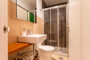a bathroom with a toilet and a sink and a shower at Homefeel Alameda in Seville