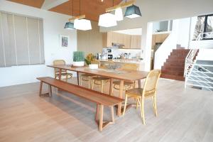 a dining room with a wooden table and chairs at B89 3BR Hillside Seaview Escape in Ban Ko Kok