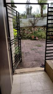 an open door to a patio with a gate at Shah Villa in Panchgani