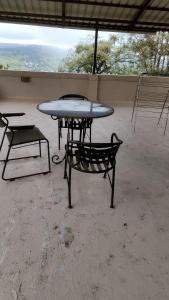 a table and a bench in a room with a table at Shah Villa in Panchgani