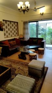 a large living room with couches and a table at Shah Villa in Panchgani