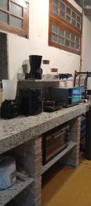 a counter top with a bunch of items on it at Catavento Flats e Suítes in Maresias