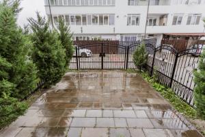 a driveway with a black gate in front of a building at APARTAMENT de LUX SIBIU in Sibiu +3 photos
