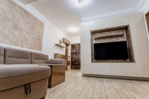 a living room with a flat screen tv on a wall at APARTAMENT de LUX SIBIU in Sibiu