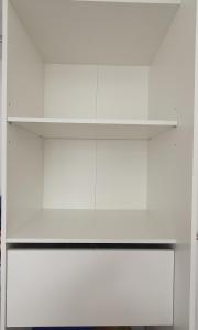 a white kitchen with white cabinets and a shelf at Chambres chez l'habitant in Saint-Paul
