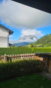 a view of a mountain through a fence at Ferienhaus - Hoamathaus in Aigen im Ennstal