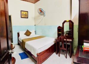a small bedroom with a bed and a mirror at royal hotel bà điểm hồ chi minh in Ho Chi Minh City
