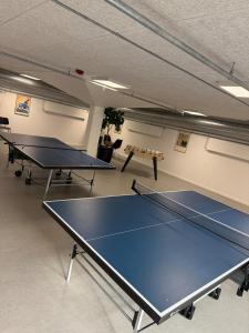 a ping pong room with two ping pong tables at Bright and inviting apartment in Frederiksberg in Copenhagen