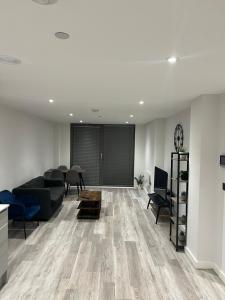 a living room with a couch and a table at Modern smart Apartments - Digbeth Central Birmingham in Birmingham