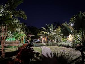 a night view of a garden with palm trees at Pousada Jardim Secreto in Teresópolis