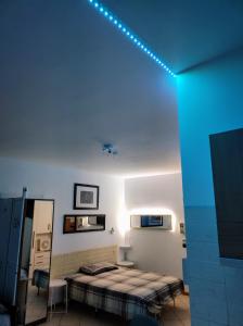 a room with a bed and a blue light on the ceiling at APARTMENT KITCHEN 5 Beds in Bologna +59 photos