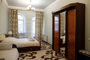 a bedroom with a bed and a large mirror at Апартаменти в Старому Місті Sweet House in Kamianets-Podilskyi