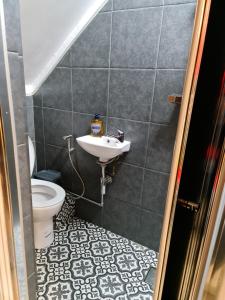 a bathroom with a sink and a toilet at The Seaside Hideaway St Leonards in Hastings +30 photos
