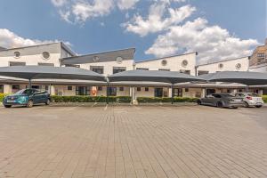 a large building with cars parked in a parking lot at Views From The 214 in Johannesburg