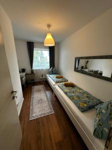 a room with three beds in it with a mirror at Zimmervermietung Wels 2 in Wels