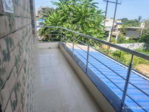 a balcony of a building with a swimming pool at New Projapati Guest House, Prantik Road in Shānti Niketan