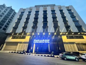 a building with a car parked in front of it at فندق كرم مضياف Karam Medyaf Hotel in Al Khansāk