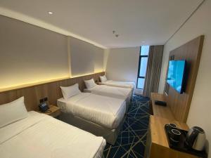 a hotel room with two beds and a flat screen tv at فندق كرم مضياف Karam Medyaf Hotel in Al Khansāk +30 photos