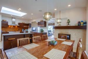a kitchen and dining room with a wooden table with chairs at GrandView in Encinitas