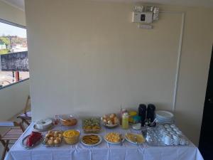a table with a bunch of food on it at Hotel Renascer pojuca in Pojuca