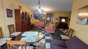 a living room with a table and chairs at Casa Rural Ambroz in Zarza de Granadilla