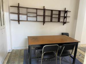 a table and chairs in a room with shelves at Nile Cruise Aswan in Luxor +1 photo