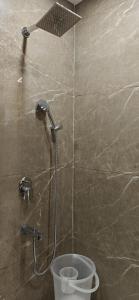 a shower in a bathroom with a toilet at Hotel Ivaan Homes opposite to Iskcon Temple East of Kailash New Delhi in New Delhi