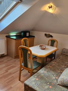 a room with a table and chairs and a bed at Apartmán Sofie Mariánské Lázně in Mariánské Lázně