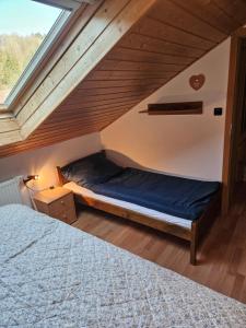 a bedroom with a bed in a attic at Apartmán Sofie Mariánské Lázně in Mariánské Lázně