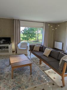 a living room with a couch and a table at Maison de location in La Malmaison